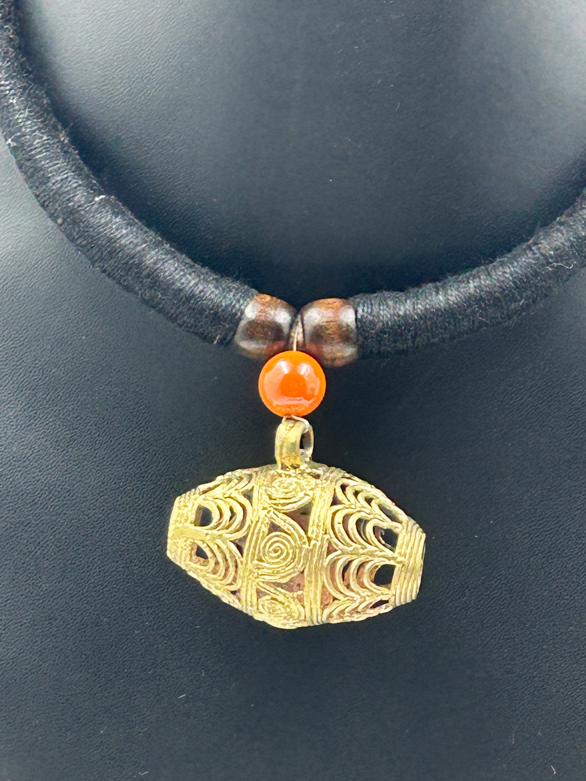 Close-up of Elara Black Dholak Dokra Necklace with Orange Bead Accent and Black Choker