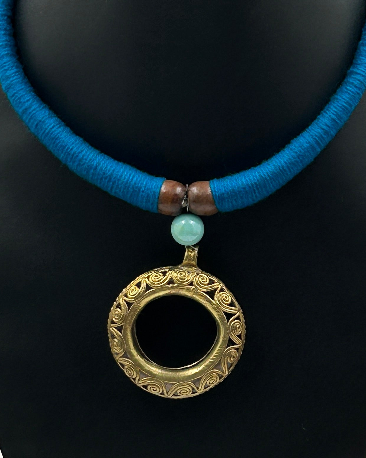 Close-up of Handcrafted Round Dokra Pendant on Blue Fabric Choker Necklace Set