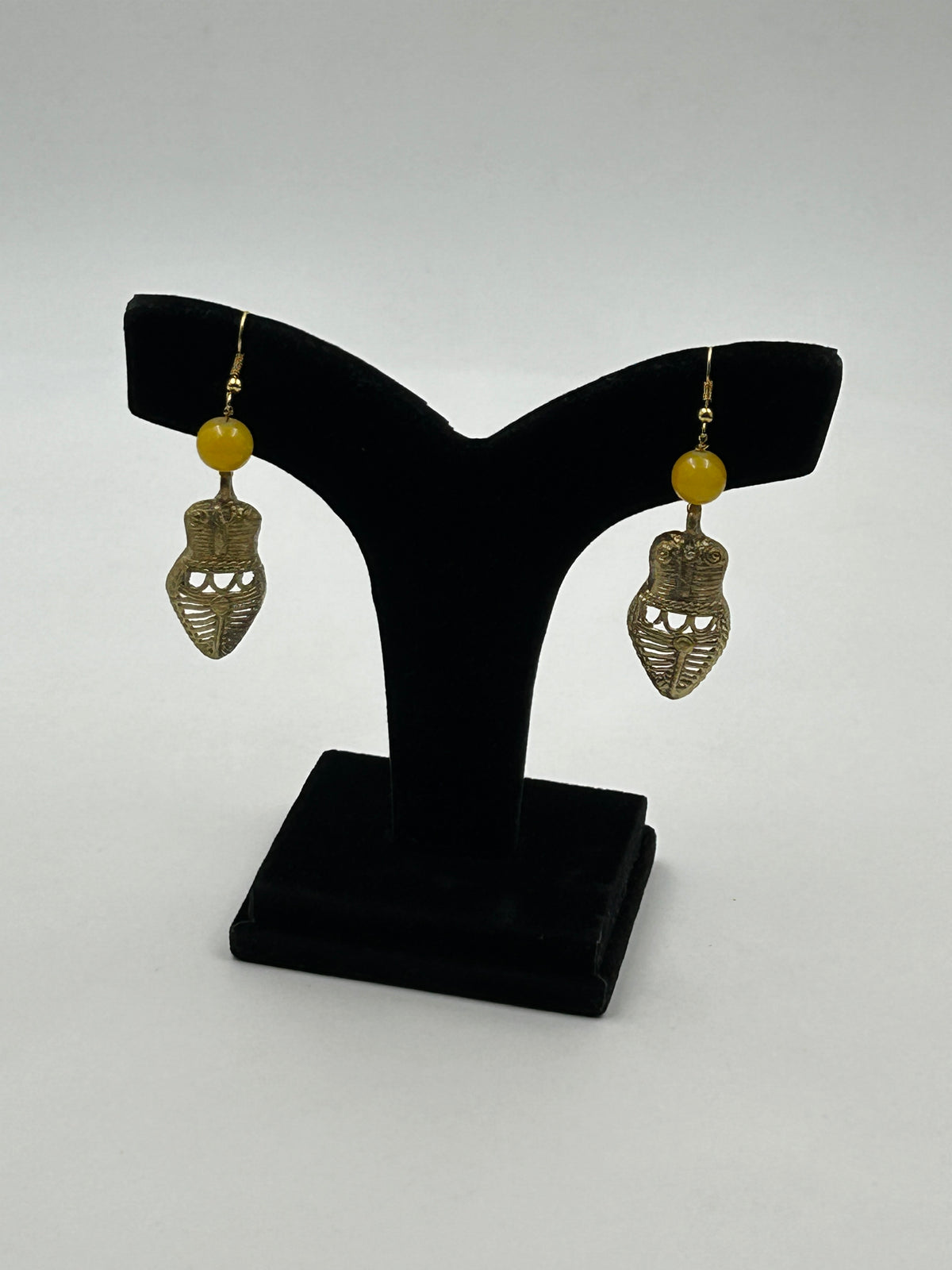 Handcrafted Dokra Owl Earrings with Tribal Design on Display Stand
